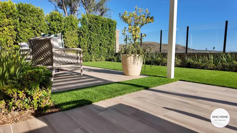Paver terrace with turf inlays and a glass view railing, NHG HOME project, Orange County