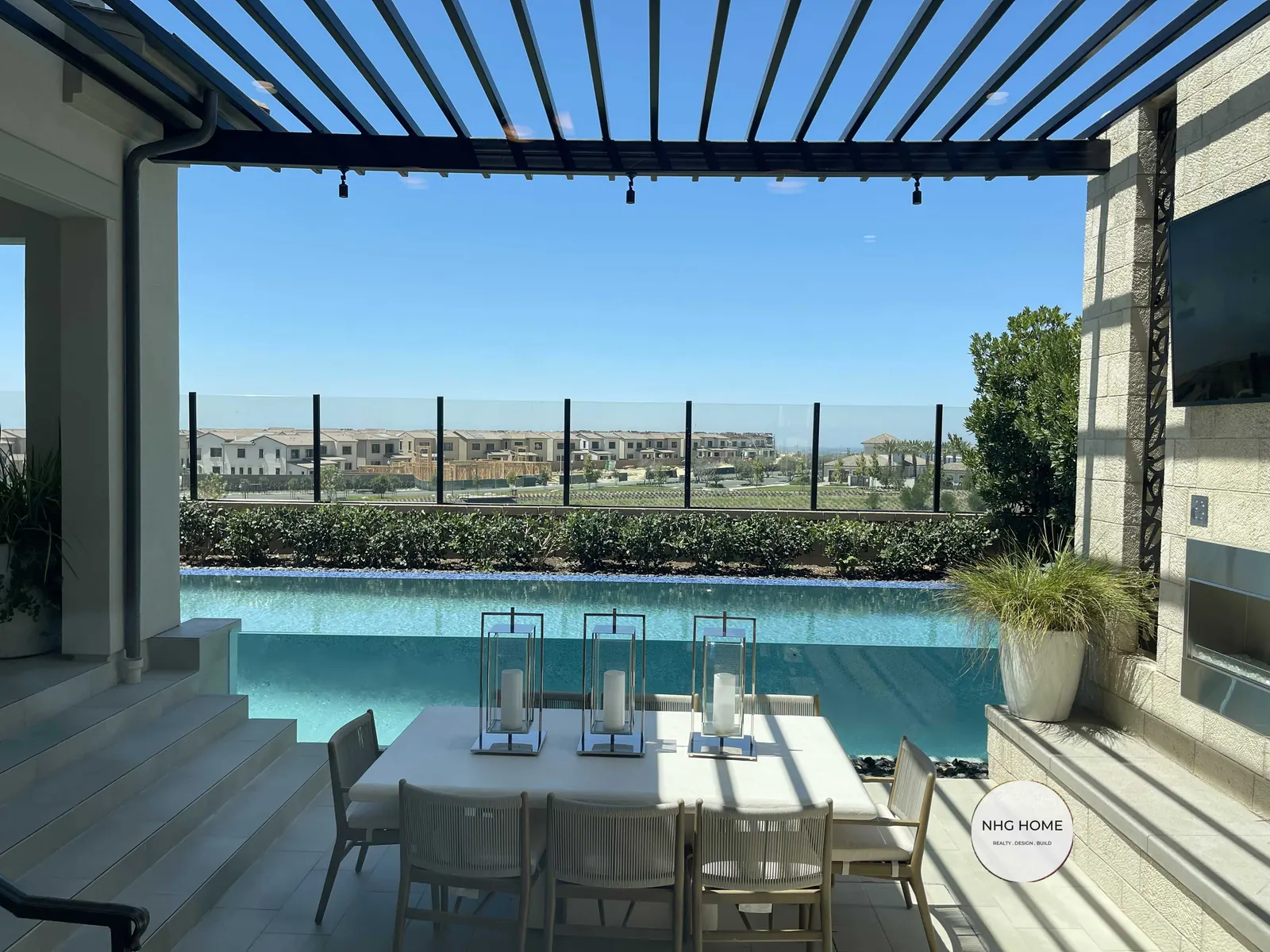 Covered outdoor dining terrace with louvered pergola and pool, NHG HOME project, Orange County
